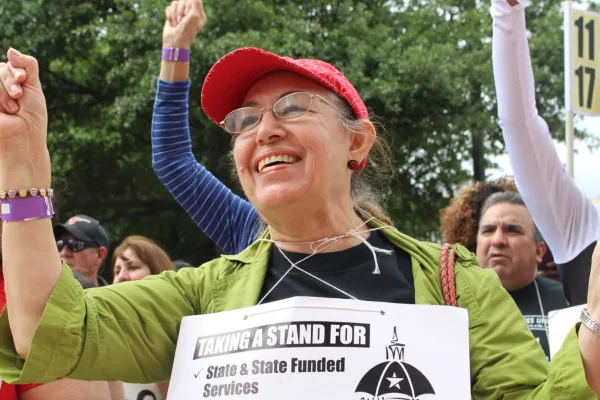 Union member holds her fist up at a rally